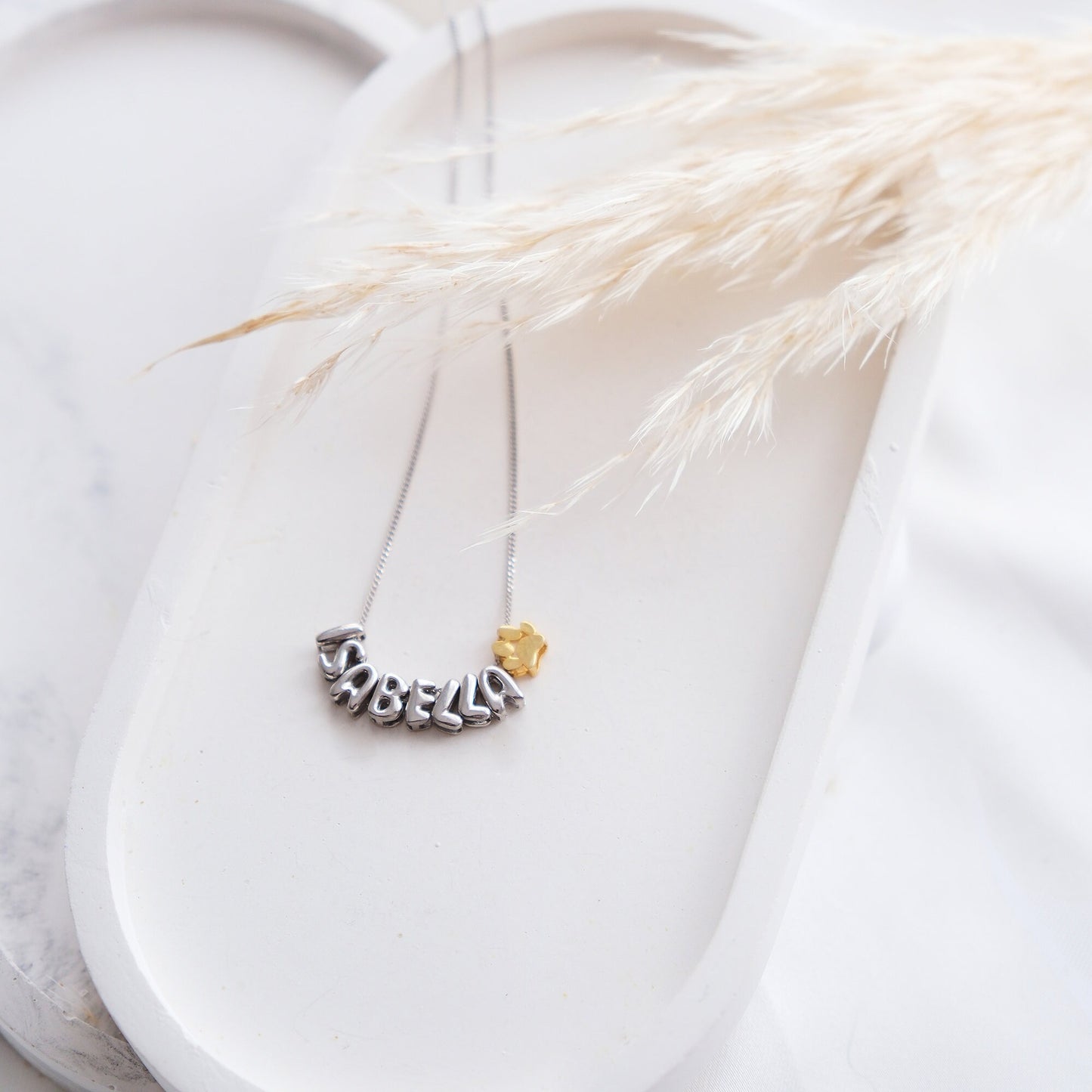 Discover our Paw Print and Balloon Necklaces perfect for personalizing with a name The playful paw print and whimsical balloon shapes add a unique touch while customizable engraving makes these pieces truly special Available in gold silver rose gold
