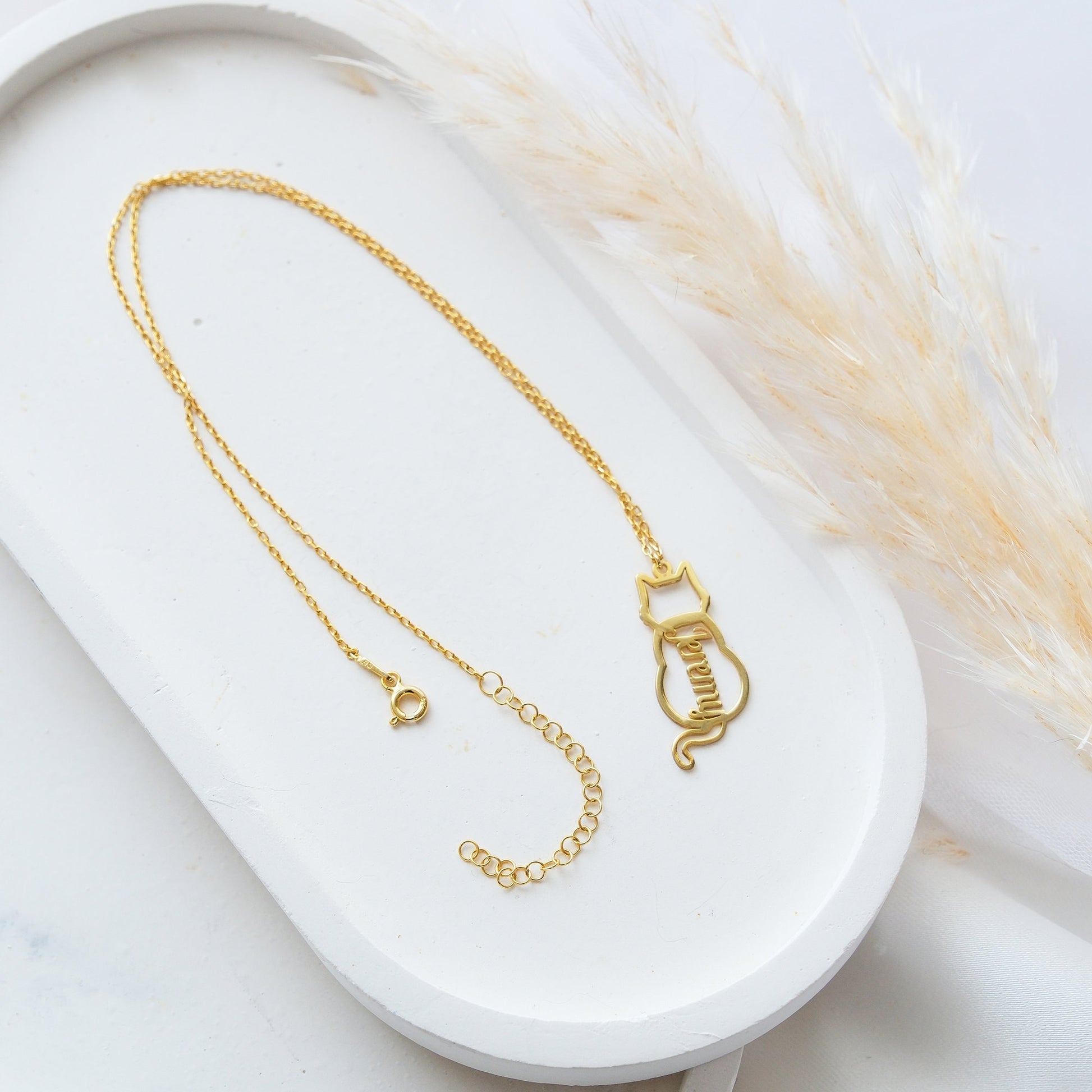 The Cat-Shaped Necklace is a stylish, playful piece perfect for cat lovers. It features a charming cat silhouette that can be personalized with a name of your choice. Available in silver, gold, and rose gold, this unique accessory adds a personal