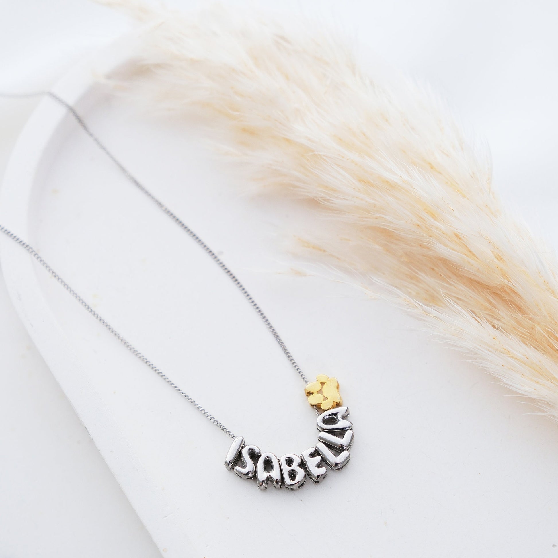 Discover our Paw Print and Balloon Necklaces perfect for personalizing with a name The playful paw print and whimsical balloon shapes add a unique touch while customizable engraving makes these pieces truly special Available in gold silver rose gold