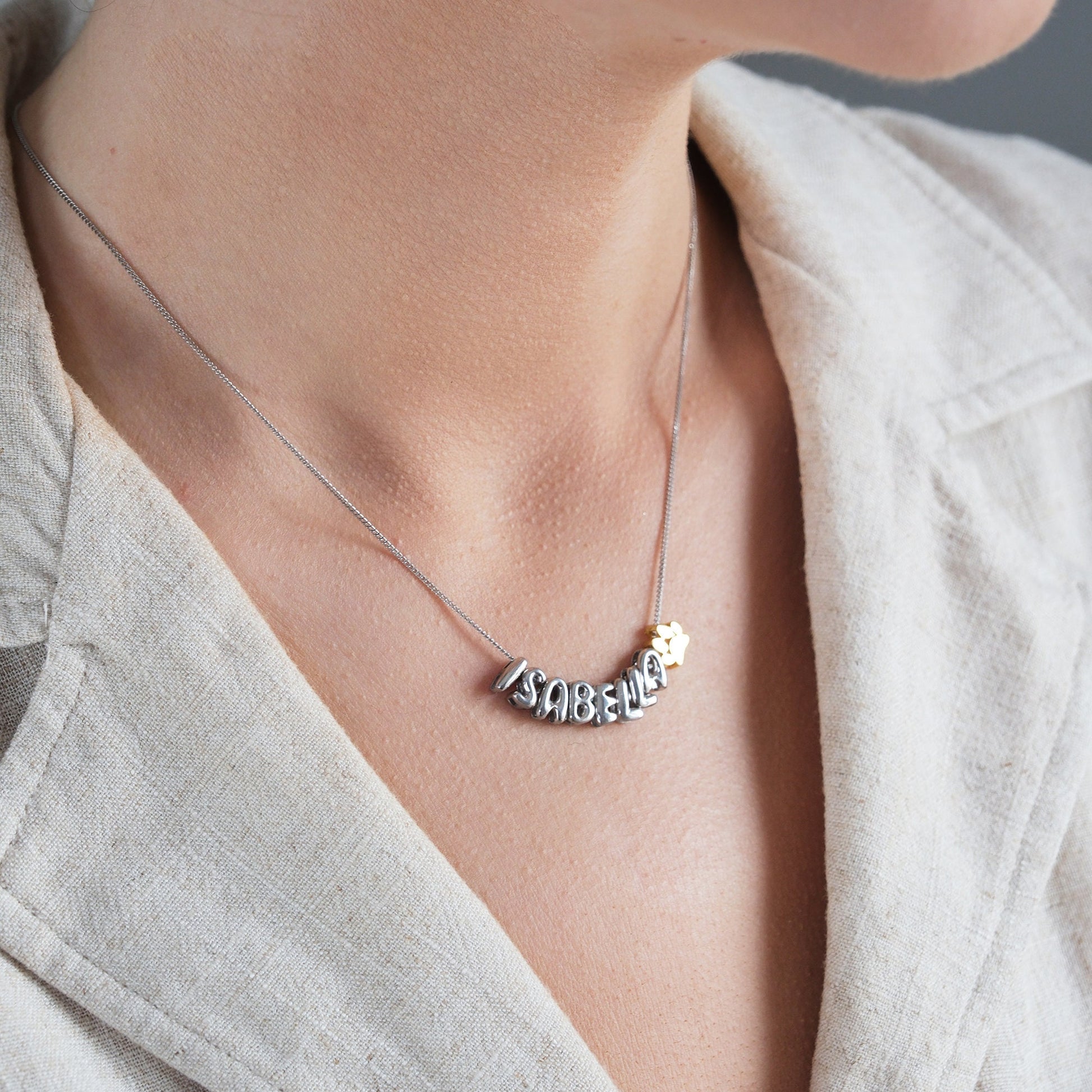 Discover our Paw Print and Balloon Necklaces perfect for personalizing with a name The playful paw print and whimsical balloon shapes add a unique touch while customizable engraving makes these pieces truly special Available in gold silver rose gold