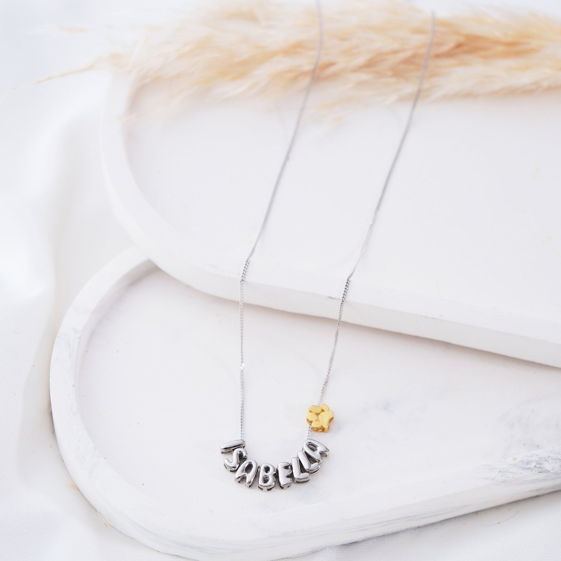 Discover our Paw Print and Balloon Necklaces perfect for personalizing with a name The playful paw print and whimsical balloon shapes add a unique touch while customizable engraving makes these pieces truly special Available in gold silver rose gold