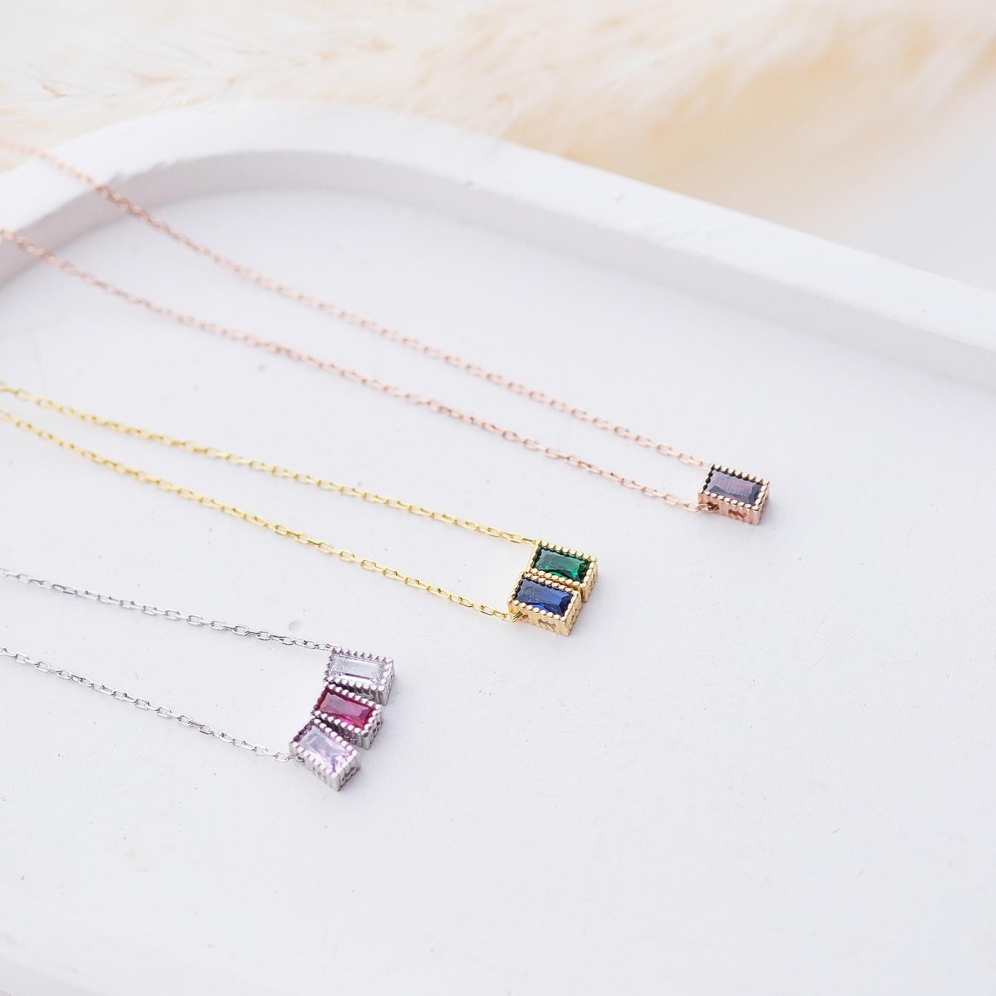 Personalize your style with our Rectangular Gemstone Necklaces. Choose a gemstone that represents you or holds special meaning. Available in gold, silver, and rose gold, these sleek, customizable pieces add a unique and elegant touch to any outfit