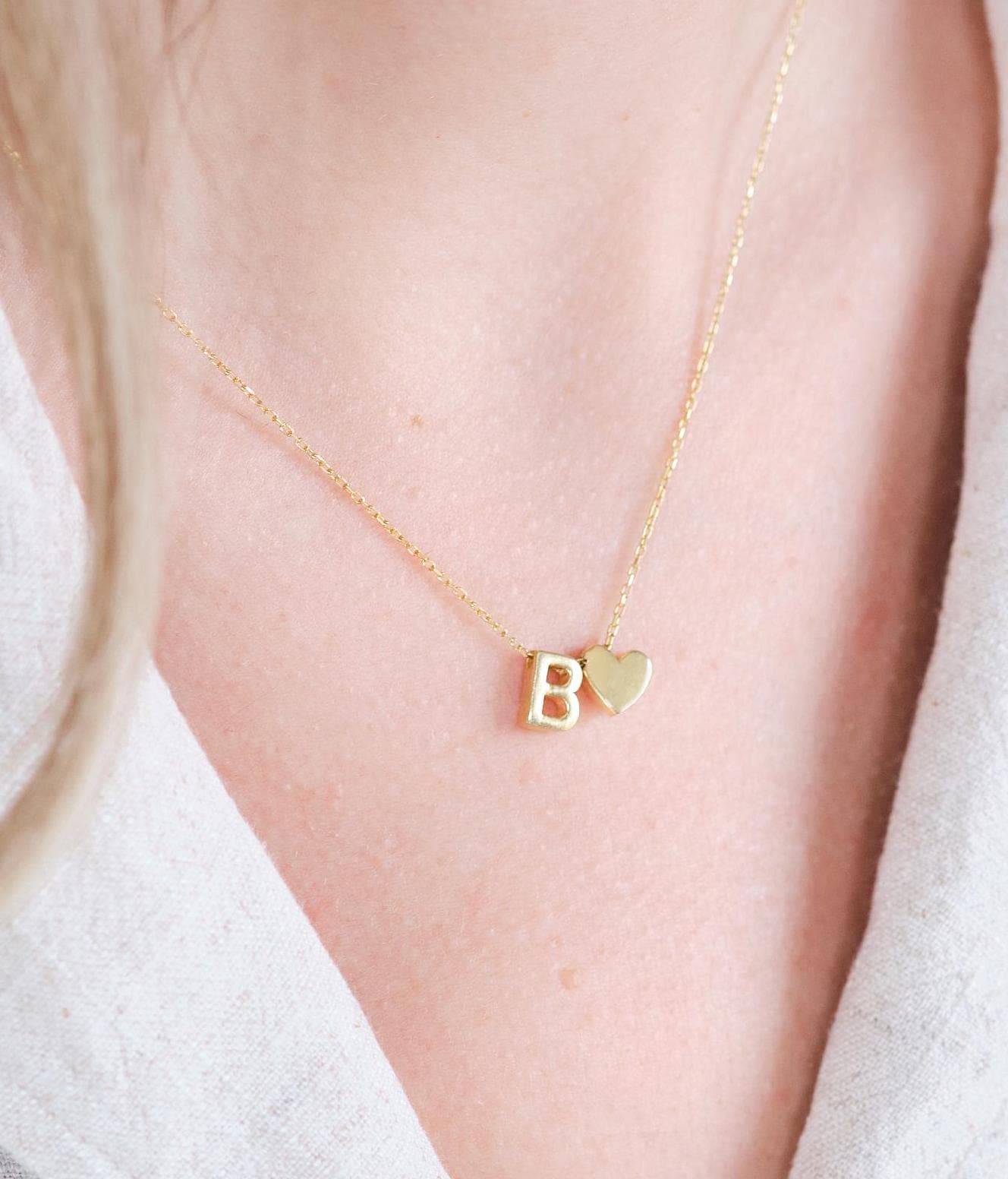 Make a bold statement with our Block Letters Necklace, featuring a heart for a touch of love. Personalize it with your name or a meaningful word. Available in gold, silver, and rose gold this piece adds a modern stylish and personal touch to any look