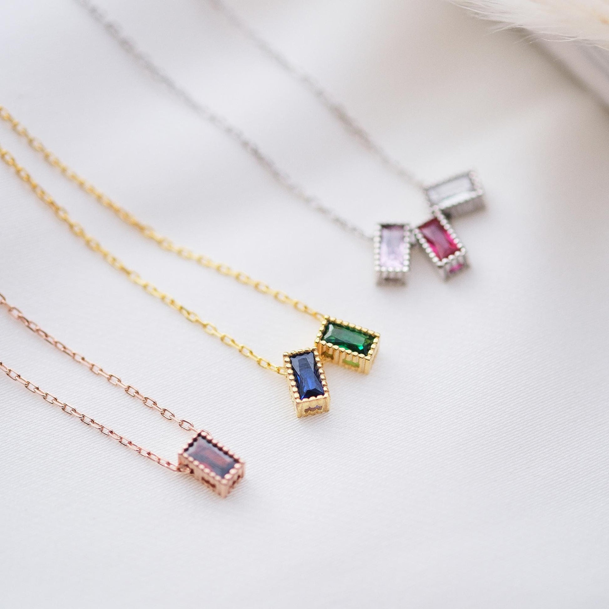 Personalize your style with our Rectangular Gemstone Necklaces. Choose a gemstone that represents you or holds special meaning. Available in gold, silver, and rose gold, these sleek, customizable pieces add a unique and elegant touch to any outfit
