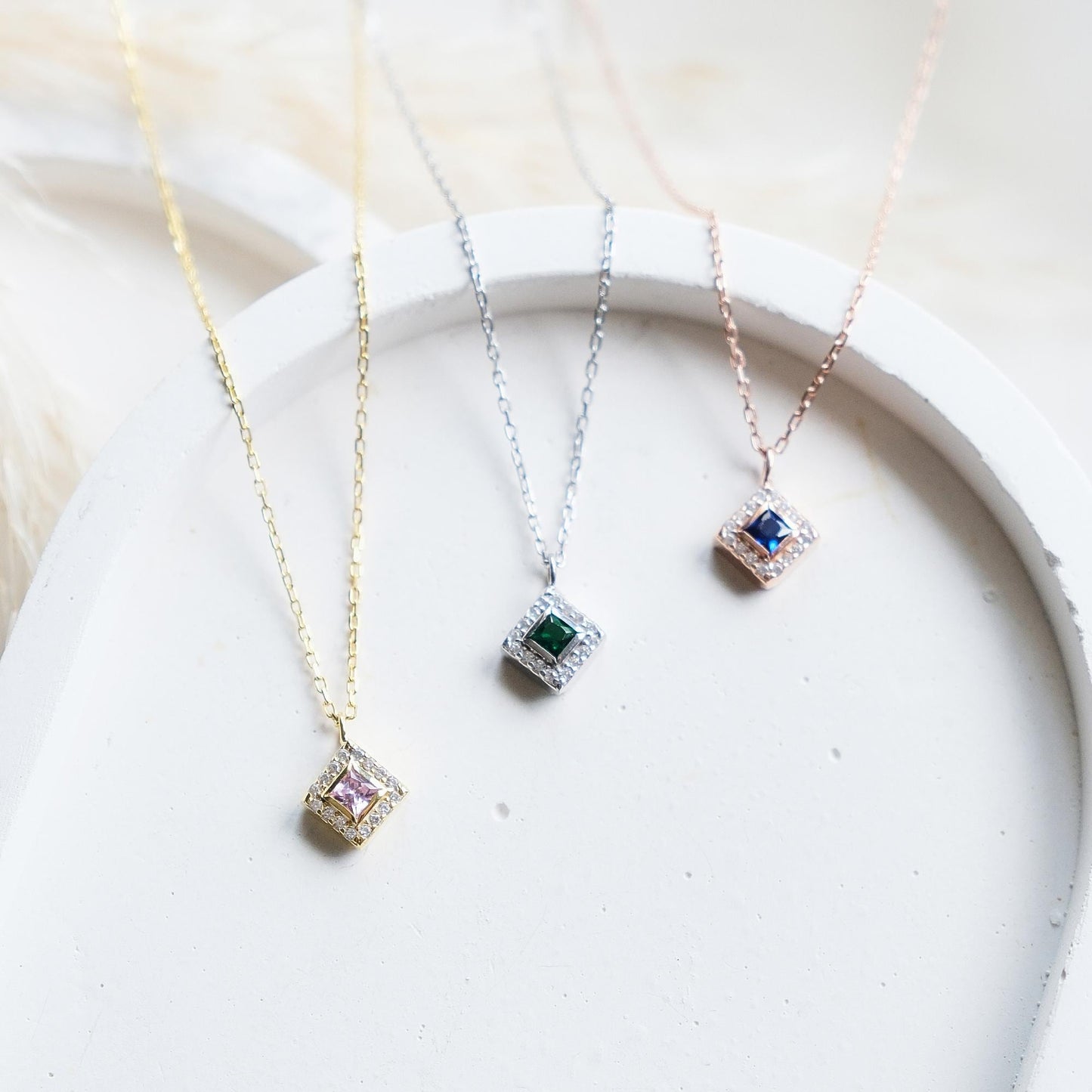 Add a bold touch with our square shaped necklaces adorned with sparkling stones along the edges and inside These stunning customizable pieces offer a blend of elegance and modern style perfect for enhancing your everyday look gifting someone special