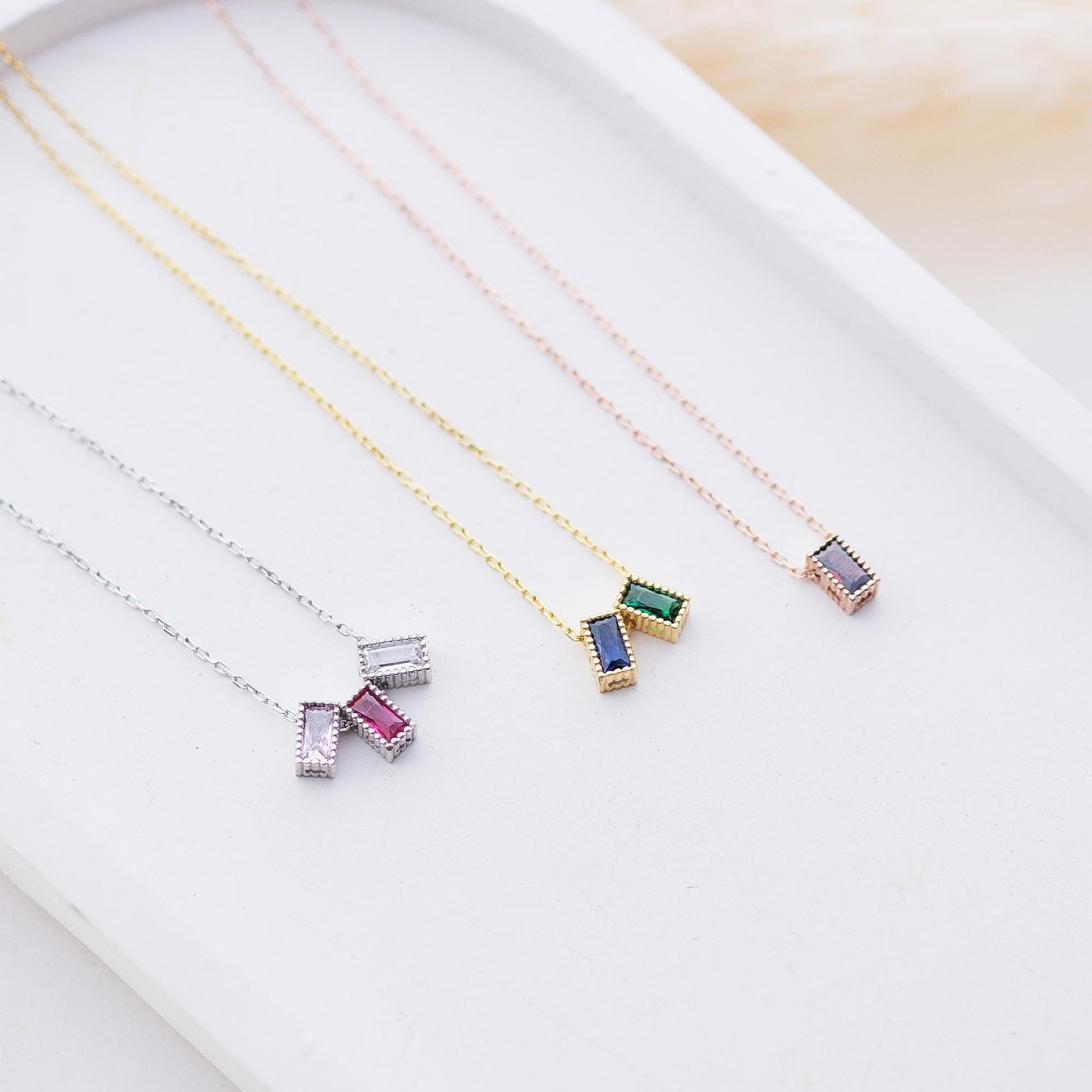 Personalize your style with our Rectangular Gemstone Necklaces. Choose a gemstone that represents you or holds special meaning. Available in gold, silver, and rose gold, these sleek, customizable pieces add a unique and elegant touch to any outfit