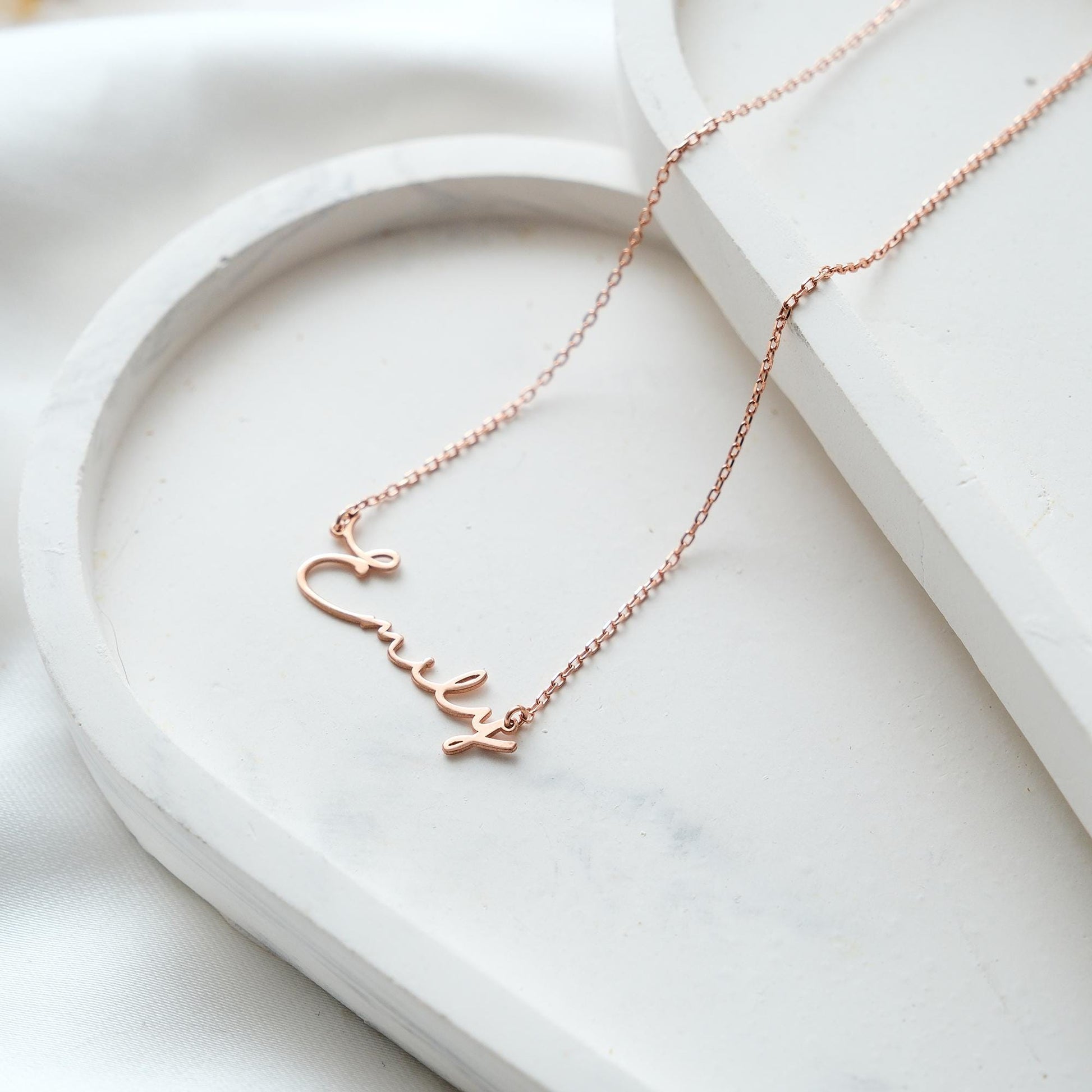Present your loved ones with a unique gift through our customizable name necklaces. Available in gold, silver, and rose gold plating, these elegant and durable designs perfectly complement personal style. Add your name, and leave a lasting impression