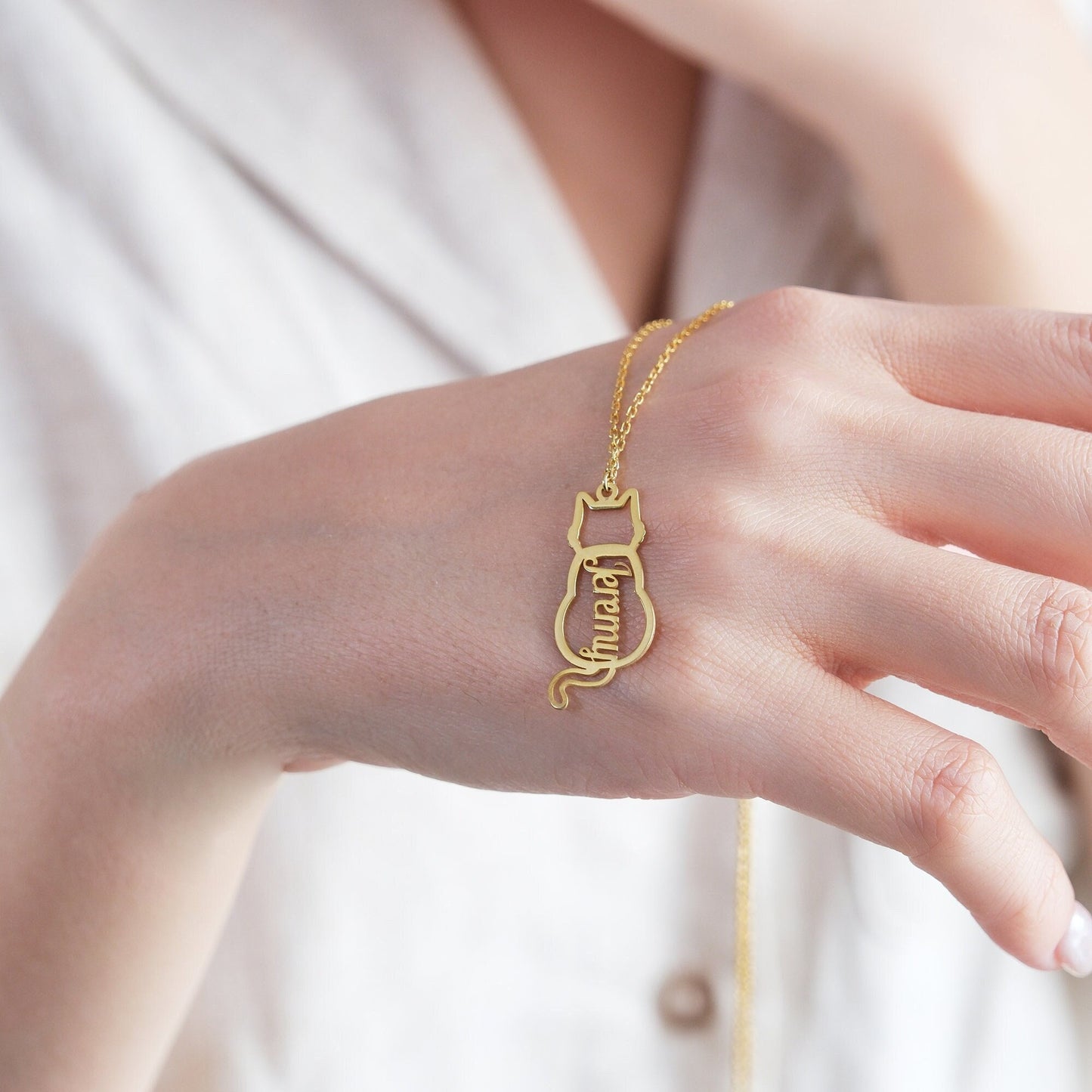 The Cat-Shaped Necklace is a stylish, playful piece perfect for cat lovers. It features a charming cat silhouette that can be personalized with a name of your choice. Available in silver, gold, and rose gold, this unique accessory adds a personal