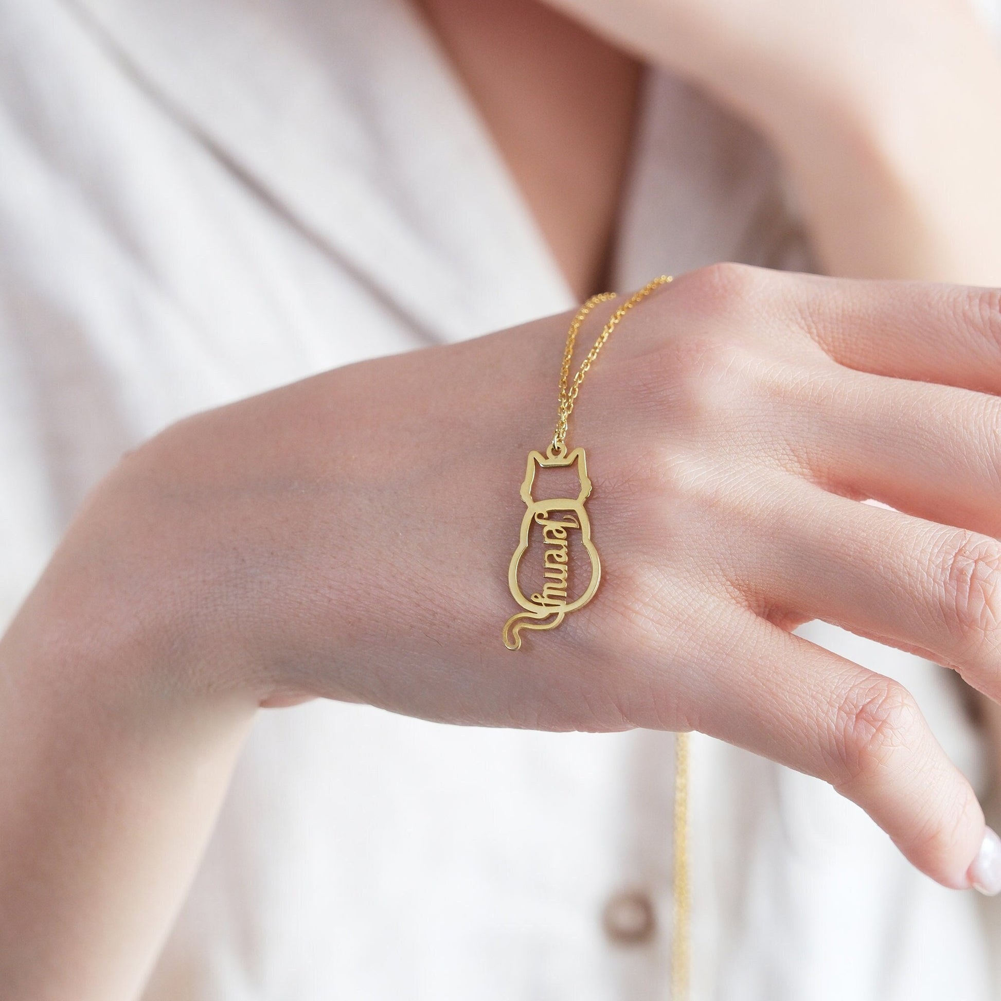 The Cat-Shaped Necklace is a stylish, playful piece perfect for cat lovers. It features a charming cat silhouette that can be personalized with a name of your choice. Available in silver, gold, and rose gold, this unique accessory adds a personal