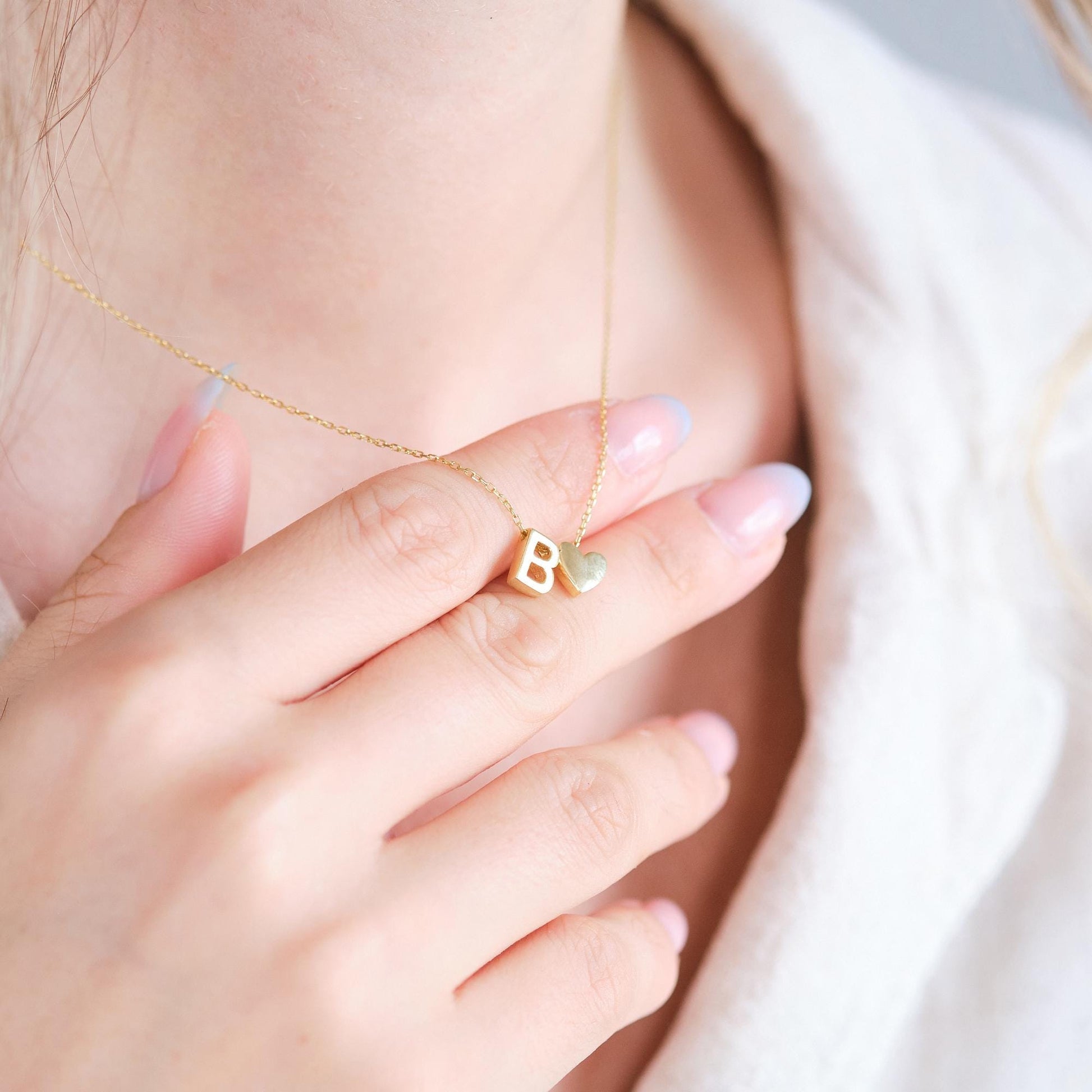 Make a bold statement with our Block Letters Necklace, featuring a heart for a touch of love. Personalize it with your name or a meaningful word. Available in gold, silver, and rose gold this piece adds a modern stylish and personal touch to any look