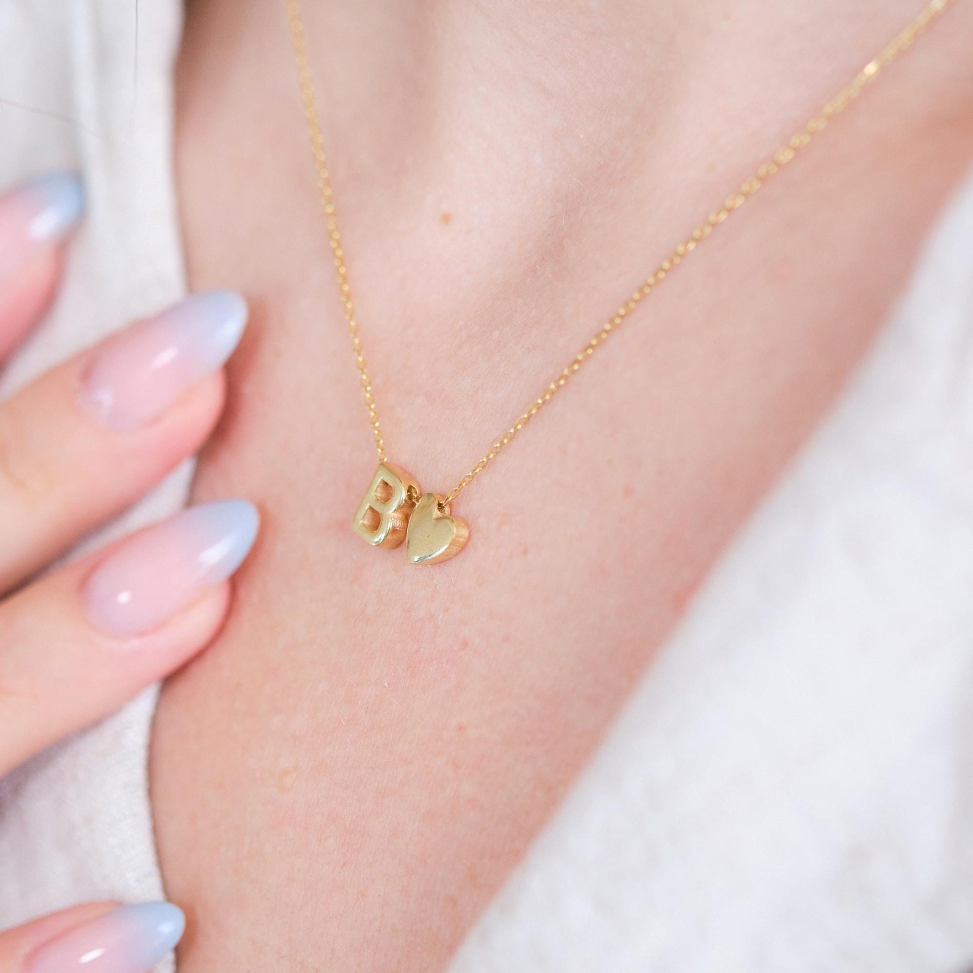 Make a bold statement with our Block Letters Necklace, featuring a heart for a touch of love. Personalize it with your name or a meaningful word. Available in gold, silver, and rose gold this piece adds a modern stylish and personal touch to any look