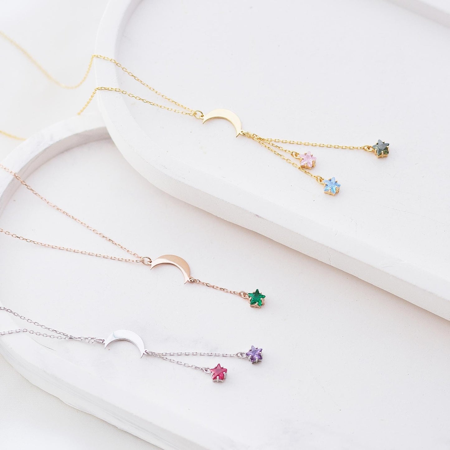Shine like the night sky with our moon and star necklaces, featuring customizable gemstones at the ends. Choose the stones that reflect your story, creating a piece that’s as unique as the stars themselves