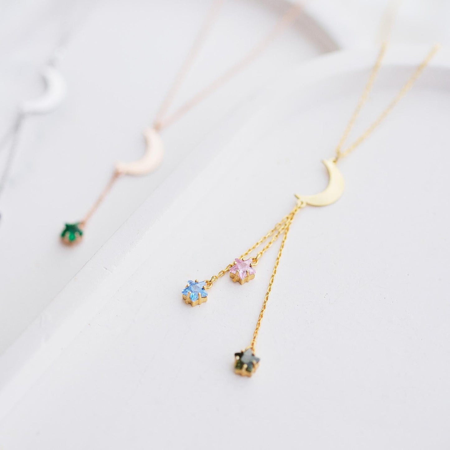 Shine like the night sky with our moon and star necklaces, featuring customizable gemstones at the ends. Choose the stones that reflect your story, creating a piece that’s as unique as the stars themselves