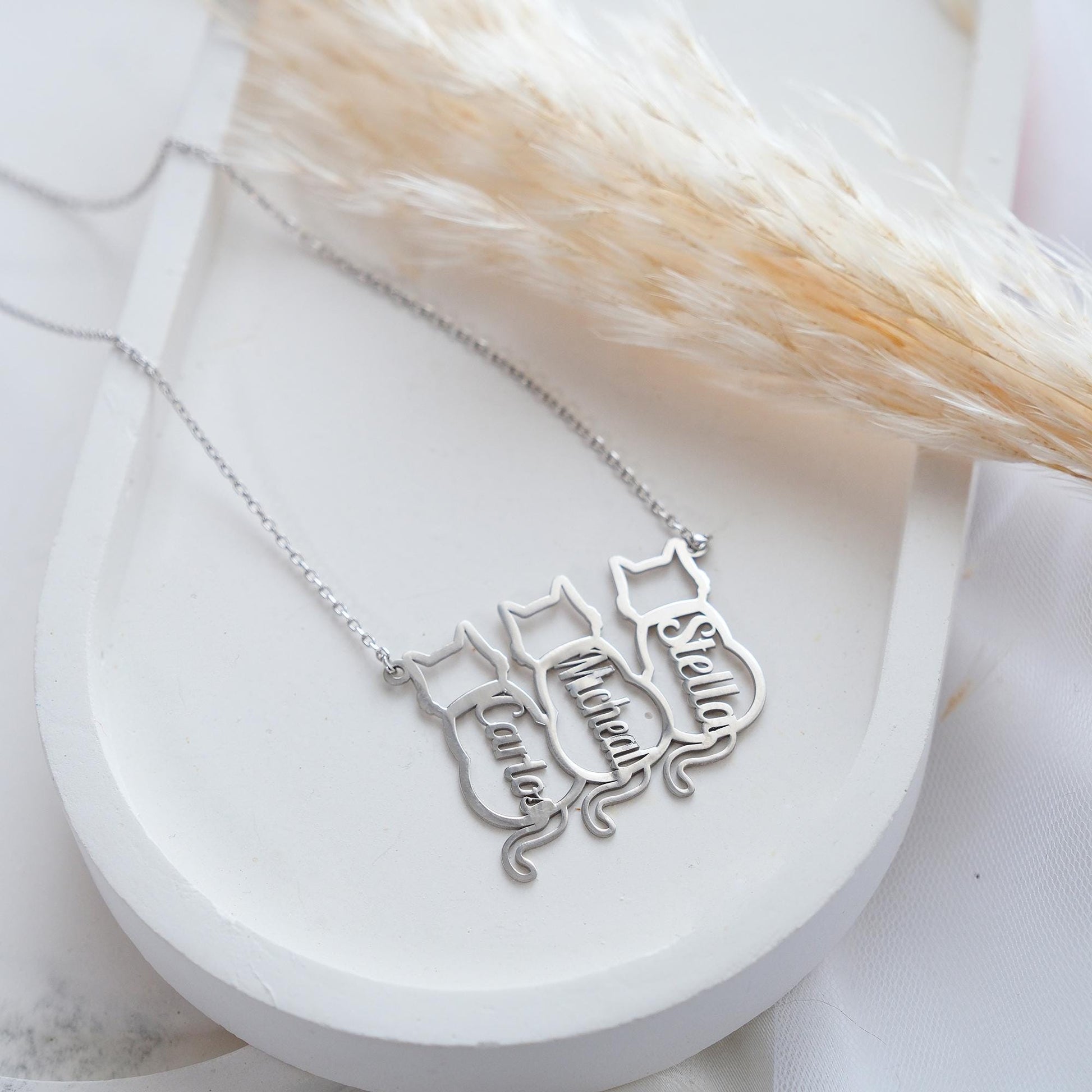 The Cat-Shaped Necklace is a stylish, playful piece perfect for cat lovers. It features a charming cat silhouette that can be personalized with a name of your choice. Available in silver, gold, and rose gold, this unique accessory adds a personal