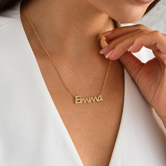 ✨ CZ Name Necklace – Dainty, Sparkly, Personalized ✨  

This elegant name necklace is custom-made with shimmering cubic zirconia stones for a touch of everyday glam. Whether it’s your own name or a loved one’s, this piece is crafted in 925K Sterling Silver / 14K Solid Gold and makes a heartfelt gift they’ll treasure.