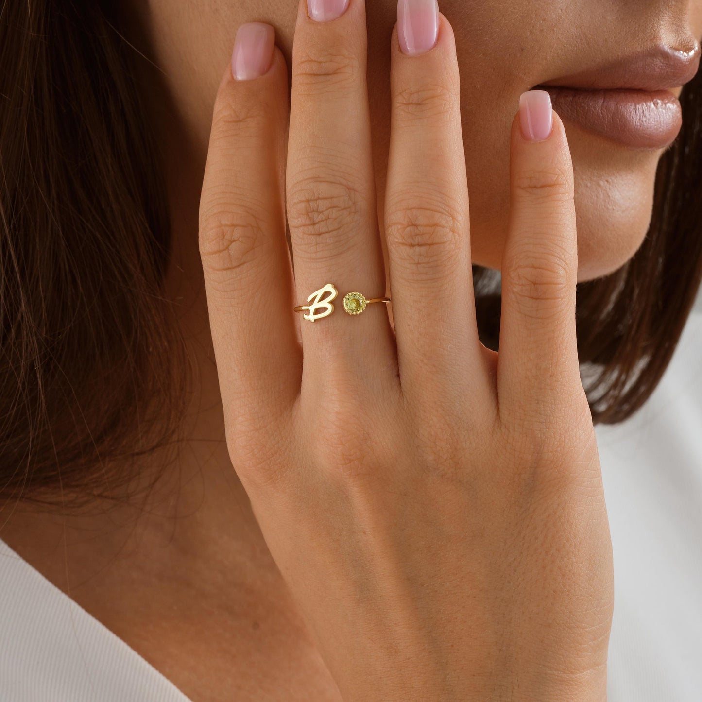 Sterling silver and gold personalized initial rings with sparkling birthstones, shown in B in different finishes.