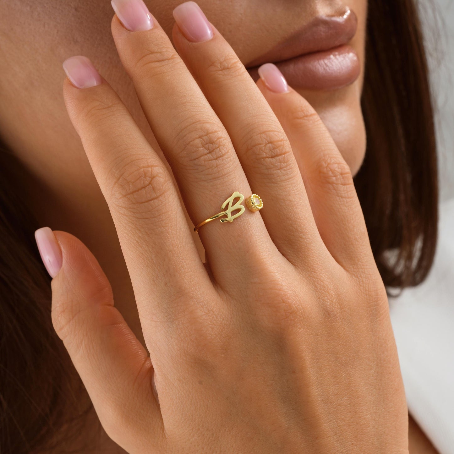 Sterling silver and gold personalized initial rings with sparkling birthstones, shown in B letter in different finishes.