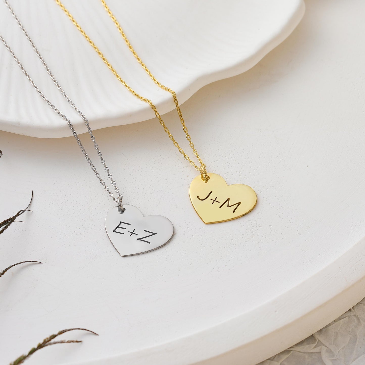Celebrate your connection with this custom heart-shaped pendant, engraved with your chosen initials. Whether it’s your partner, child, or best friend – this simple and meaningful necklace is designed to keep your bond close every day.
Material: 925K Sterling Silver / 14K Solid Gold  
Pendant: Heart-shaped plate engraved with up to 2 initials (e.g. J+M)  
• Chain Length: Adjustable (16&quot; + 2&quot; extender)  
Anniversary – Couples – Friendship – Family initials – Sentimental gifts – Everyday wear