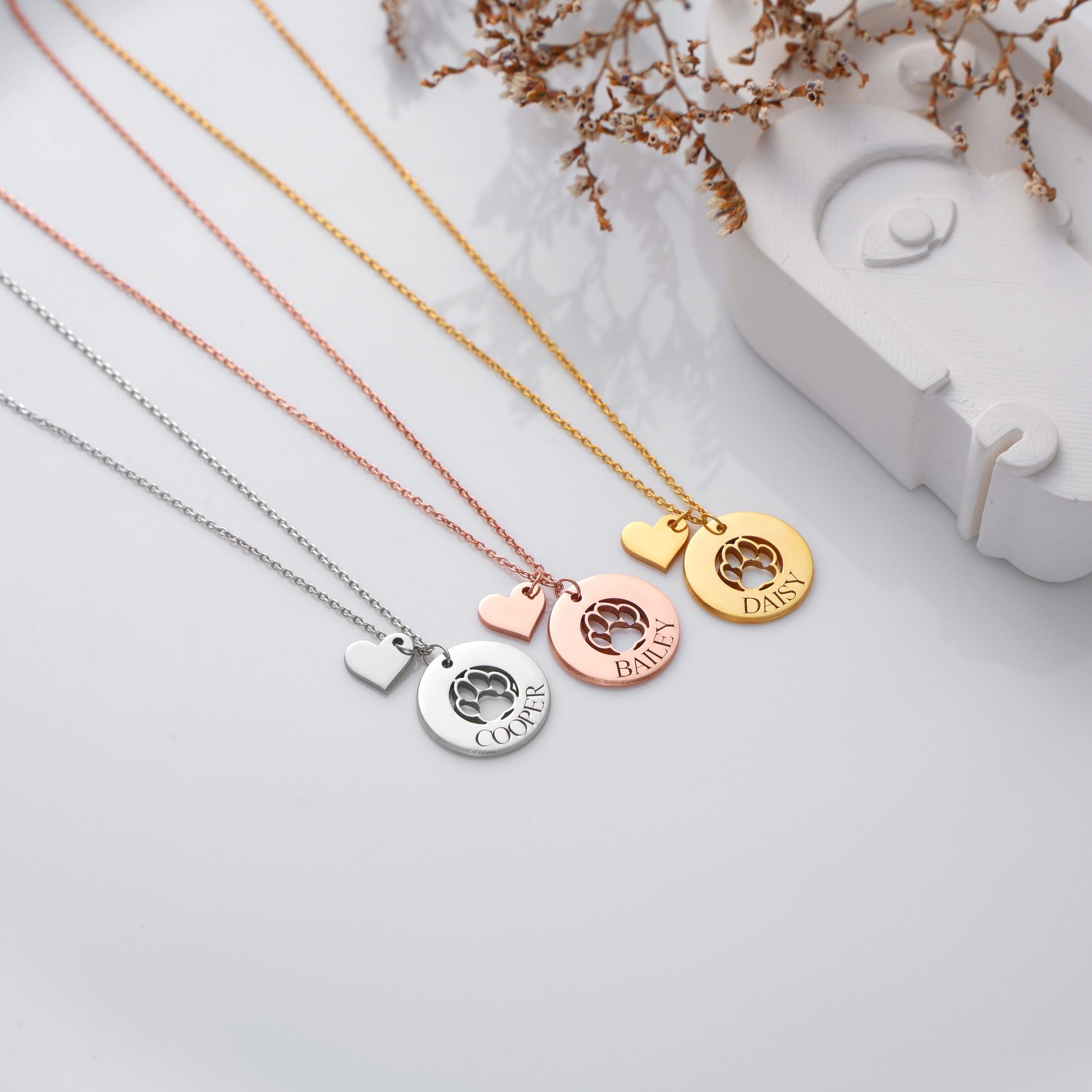 Paw Name Necklace with Heart Charm – A Loving Tribute to Your Pet Celebrate the bond with your furry friend with this customizable paw print name necklace, featuring a sweet heart charm. Perfect as a gift for pet lovers or a keepsake to remember a beloved companion.  
• 925K Sterling Silver / 14K Solid Gold  
• Silver, Gold, Rose Gold  
• Pendant: Paw cut-out with engraved name + heart charm    
Pet memorial gifts – Dog lovers – Cat lovers – Pet owners – Animal rescue supporters