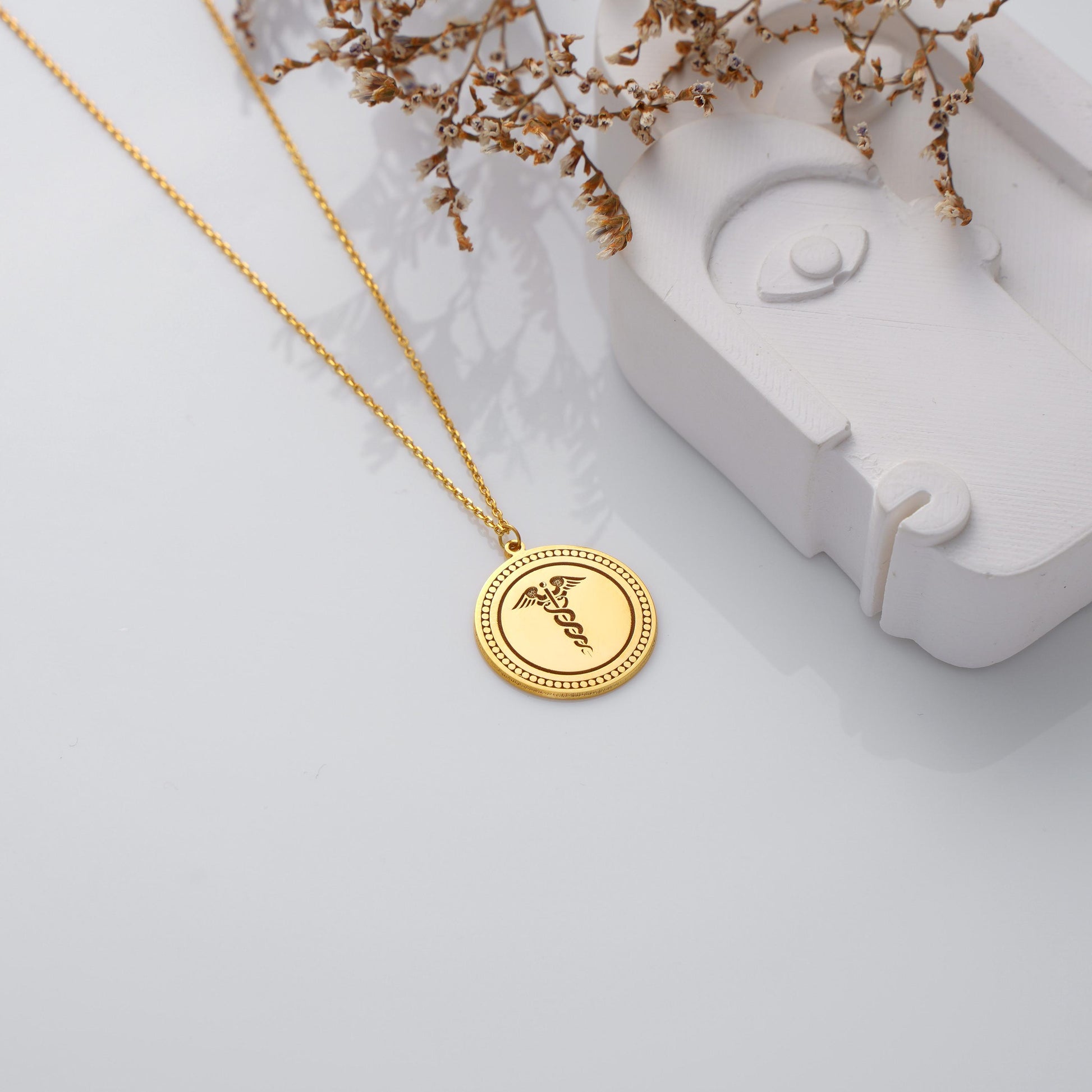 Engraved Caduceus Pendant – Medical Symbol Necklace
A meaningful necklace featuring the caduceus symbol, representing health, medicine, and healing. Perfect gift for doctors, nurses, and medical students.
• Material: 925K Sterling Silver / 14K Solid Gold
• Closure: Spring Ring
• Pendant Size: Approx. 20mm diameter
• Sold as: Pendant with chain included
• Hypoallergenic & safe for sensitive skin
Doctor Gift – Nurse Gift – Medical Student – Graduation – Everyday Wear – Healthcare Workers