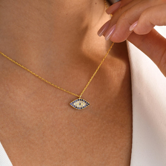 ✨ CZ Evil Eye Charm Necklace – Protective Amulet Jewelry ✨

A stunning and symbolic necklace featuring a CZ-studded evil eye charm, known for protection and good fortune. Perfect for daily wear or as a meaningful gift.
🎯 Perfect For:
Daily wear, protective talisman, birthday gift, anniversary, or special occasions.

💛 Product Details
• Material: 925K Sterling Silver / 14K Solid Gold
• Closure: Spring Ring
• Pendant Size: Approx. 15mm
• Hypoallergenic & safe for sensitive skin